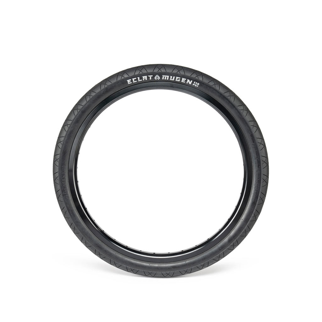 The ECLAT Mugen 18-inch bicycle tire, available in black, boasts a high-performance, textured tread pattern that provides exceptional grip. It is designed to be the perfect flatland tyre and is showcased against a white background.