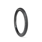 The ECLAT Mugen Tyre is a black bicycle tire that delivers high performance with its textured tread pattern, offering superior grip against a white background.