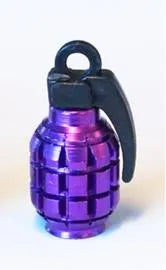 A single, grenade-shaped valve cap in purple, perfect for adding flair to any gear enthusiast’s collection with its black ring and lever, just like a cool keychain.