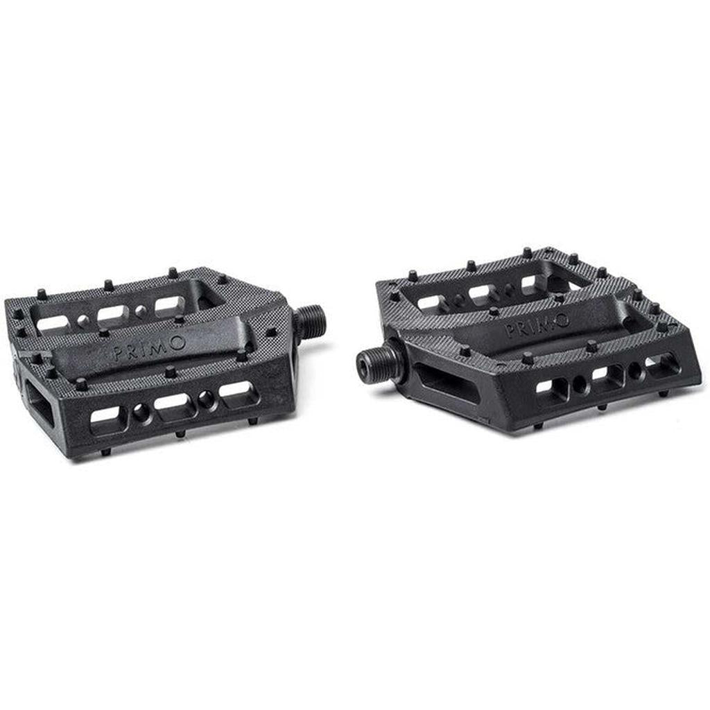 Two black Primo Turbo Pedals, featuring textured surfaces and multiple rectangular cutouts for versatile foot placement, are arranged side by side on a plain background. Ideal for perfecting crank-arm grinds.