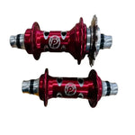 Two red PROFILE Limited Edition Cat's Eye Hubs with black and silver accents, small circular cutouts, and a "P" logo. One hub includes a gear cog.