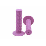 Two Kastan Grips in pink with circular patterns, made from authentic-era rubber, are displayed with one upright and the other lying flat.