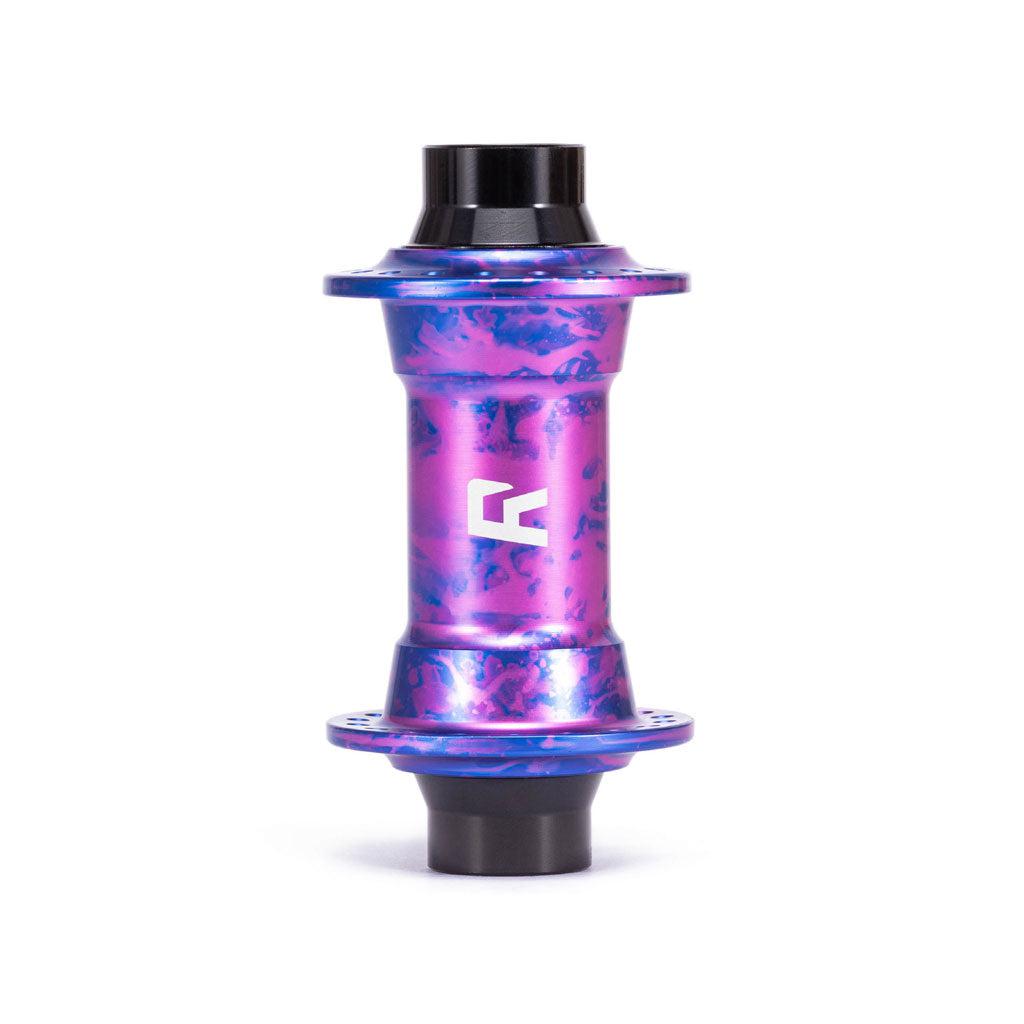 A colorful metallic Radio Sonar Front Hub (32 Hole) with a marbled purple and blue design, crafted from 6061-T6 alloy, featuring a white "R" logo in the center—perfect for street, slopestyle, or dirt riding.