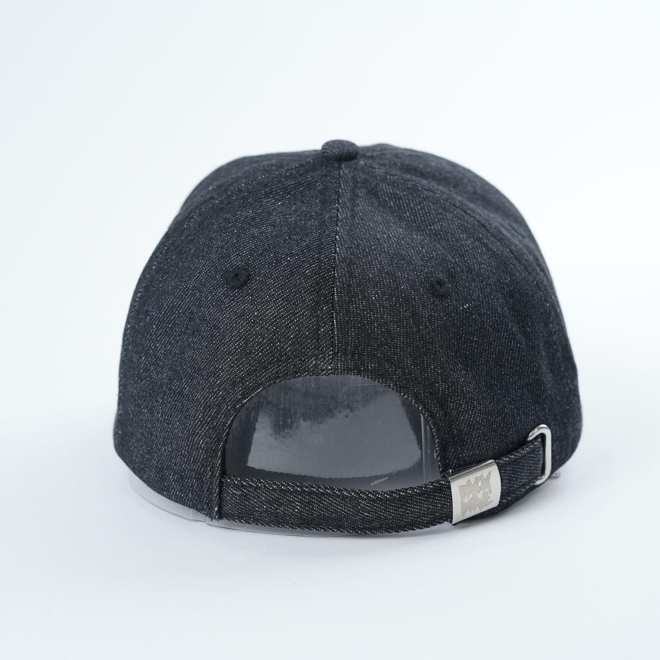 Back view of the Backbone Real Deal 6 Panel Hat, a stylish black baseball cap featuring the Backbone Skull logo, adjustable strap, and metallic clasp for a perfect fit.