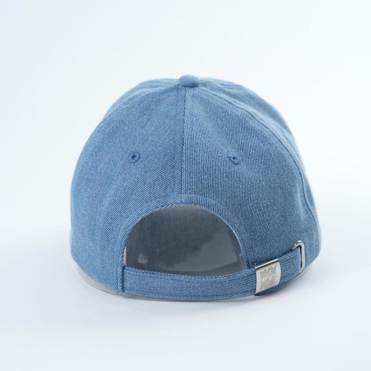 Backbone Real Deal 6 Panel Hat in blue denim, shown from the back with an adjustable strap and metal clasp, featuring a subtly embroidered Backbone Skull logo.