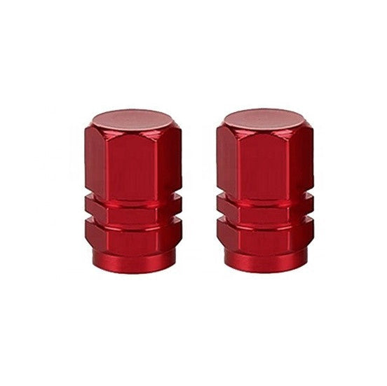 A pair of Hexagon Valve Caps in red, placed against a white background, adds a splash of color to the neutral setting.