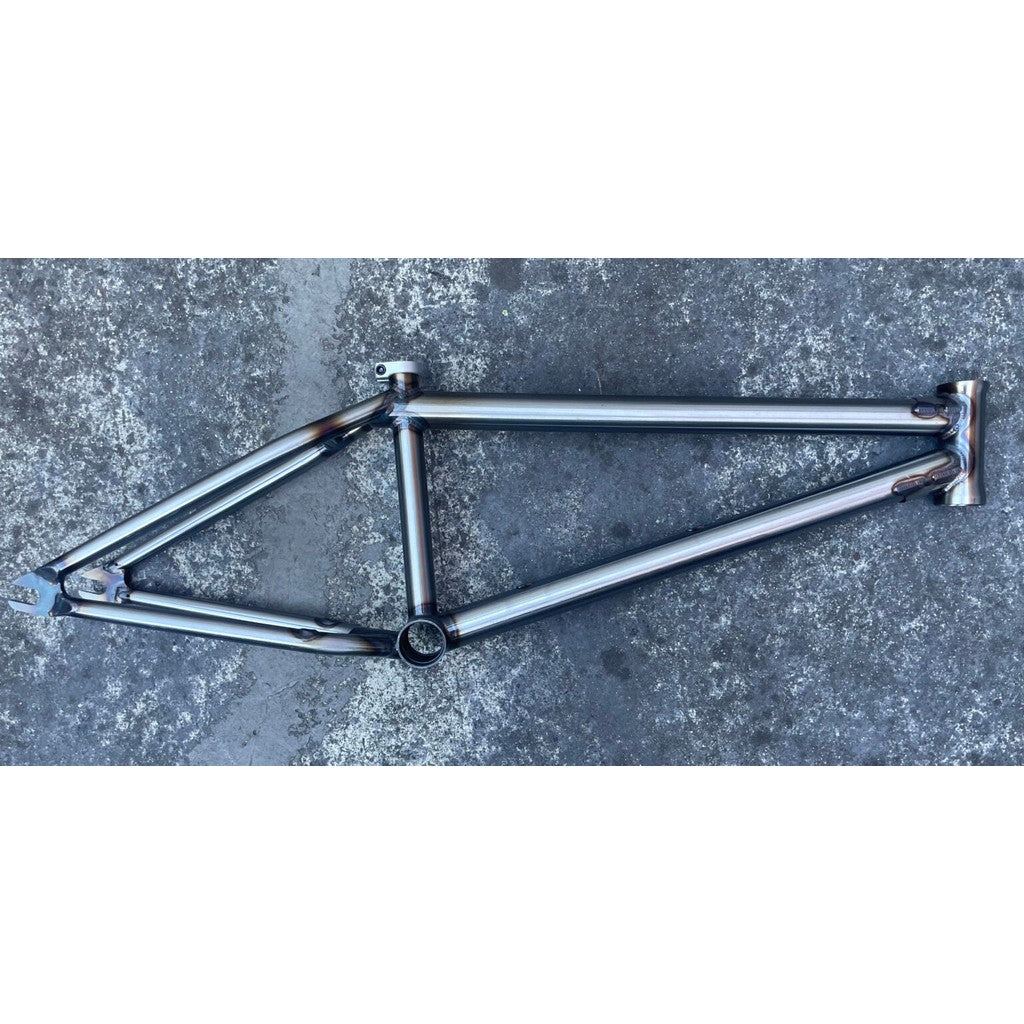 The Terrible One 2024 Skapegoat Frame rests on a textured gray surface, showcasing its welds and structure.