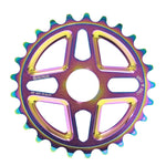 The SALTPLUS Center Front Sprocket boasts a rainbow metallic finish and features 25 teeth along with bolt markings. This lightweight bicycle sprocket is CNC machined from a durable alloy to ensure optimal performance.