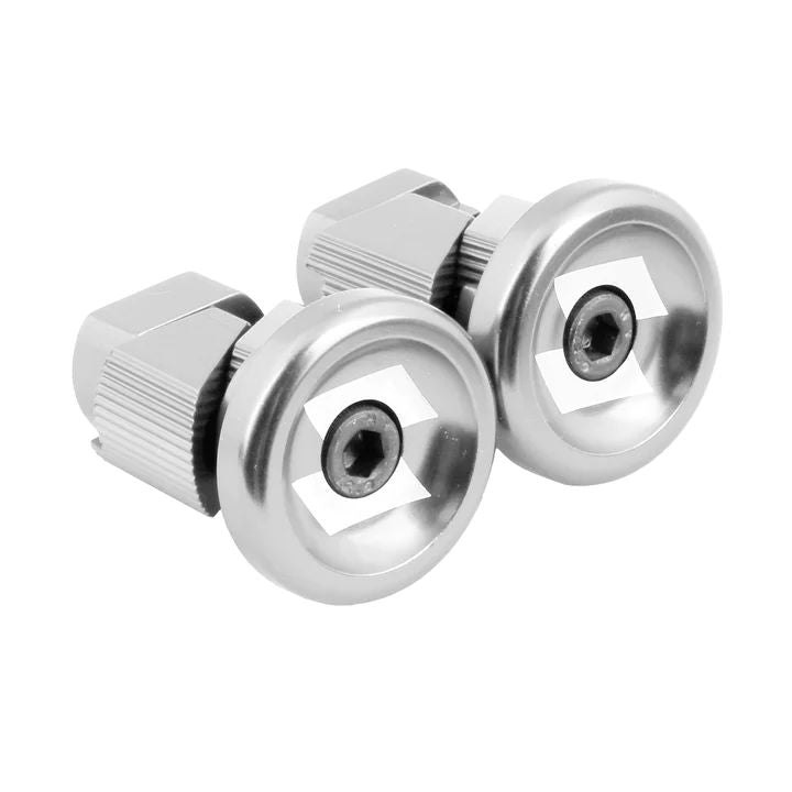 Two gleaming, silver alloy stubby bar ends with a hexagonal socket head, crafted from cold-forged material, arranged side by side on a white background.