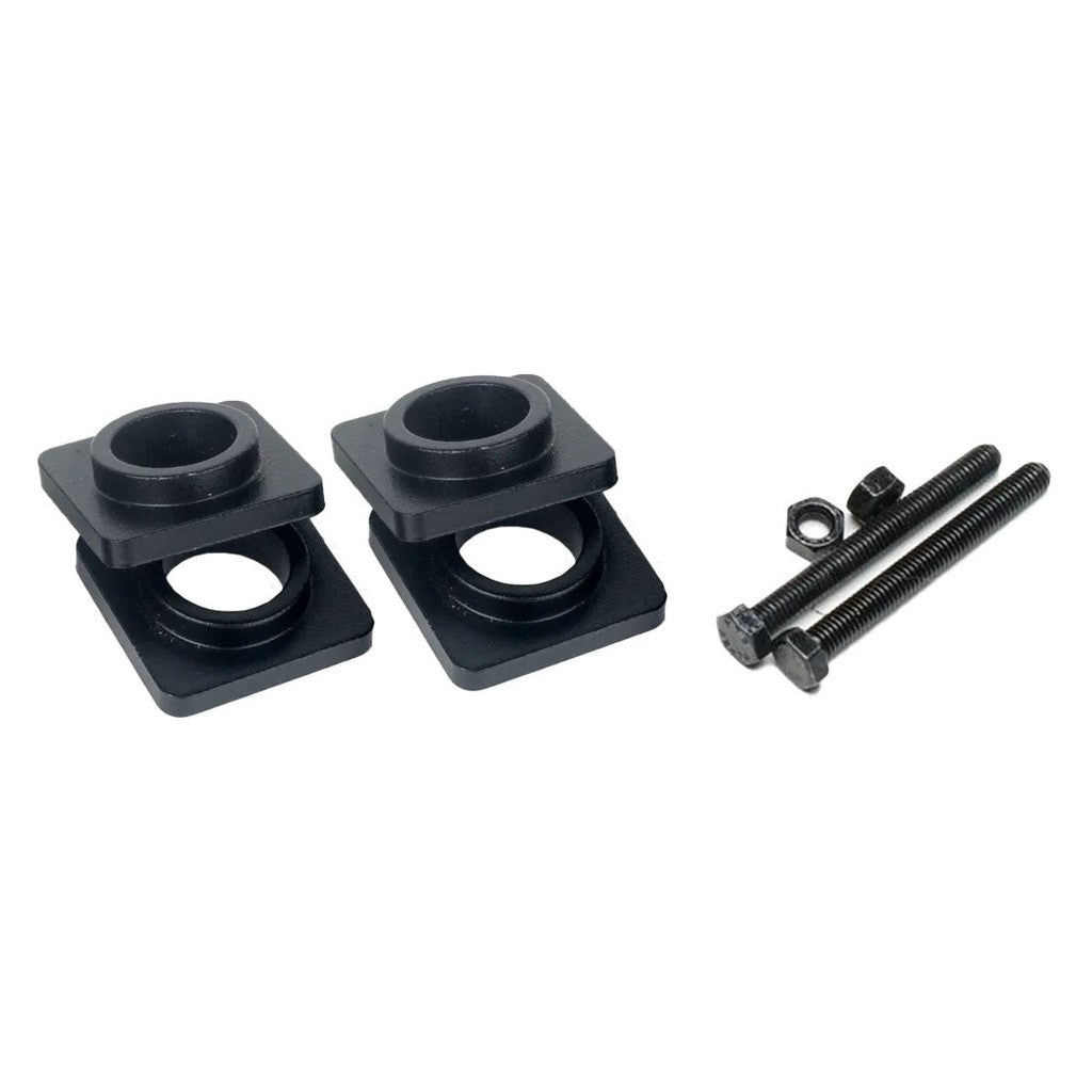 Positioned side by side are two black metal Speedco Velox V3 Dropout Spacers with circular cutouts and square bases, compatible with 10mm, 15mm, and 20mm setups. To the right, two bolts, a washer, and a nut are neatly arranged. These replacement dropout adapters are designed for the Speedco Velox Pro.