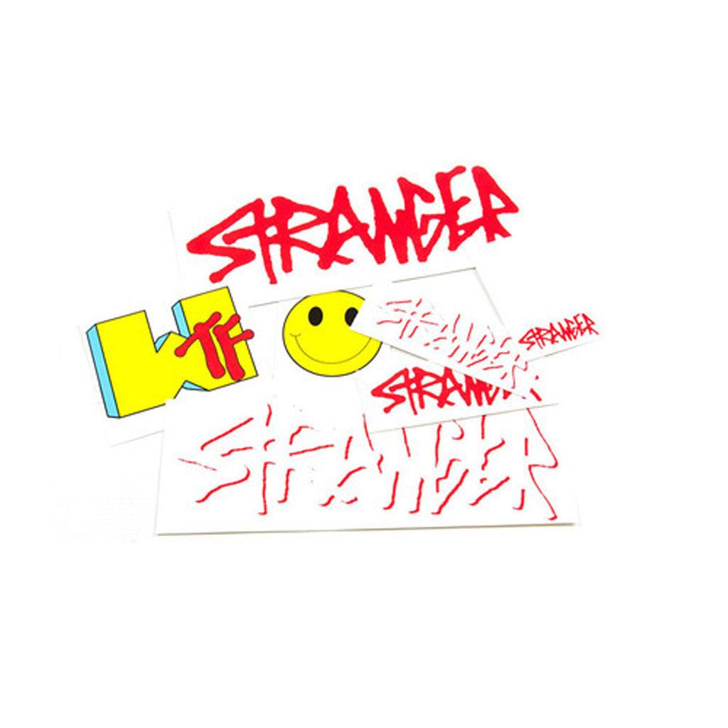 An **Stranger Assorted Sticker Pack** featuring graffiti-style text stickers, including "STRANGER" in red, "WTF" in yellow and blue, and a yellow smiley face.