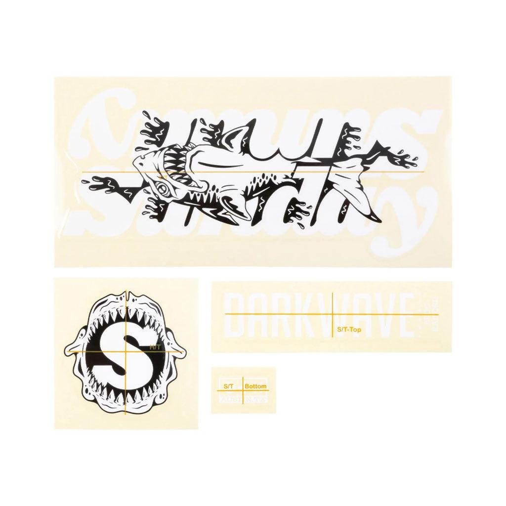 The Sunday Darkwave Frame Decal Set includes assorted decals such as a shark with text "Sea Smith" and "Darkwave," a stylized "S" with teeth, along with application instructions on a yellow background. These decals are perfect for adding personality to your Broc Raiford Darkwave Frame or as part of a comprehensive sticker kit.