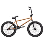 A bronze-colored Kink Switch 20 Inch Bike with a robust Chromoly frame, featuring black handlebars, black tires, and a black seat, viewed from the side.