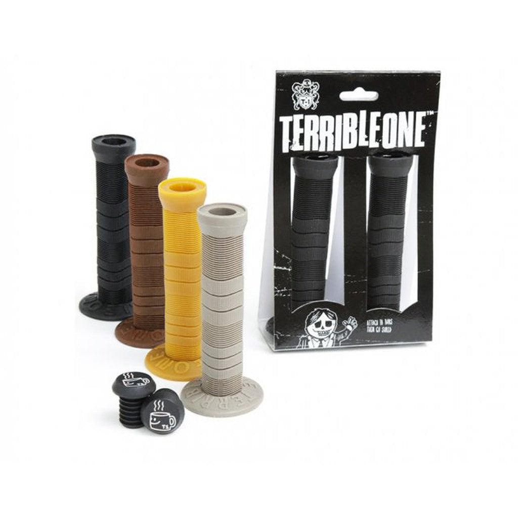 A set of four colored bicycle grips (black, brown, yellow, gray) is displayed in front of a black box labeled "Terrible One Joe Rich Grips," which contains an additional pair of black grips.