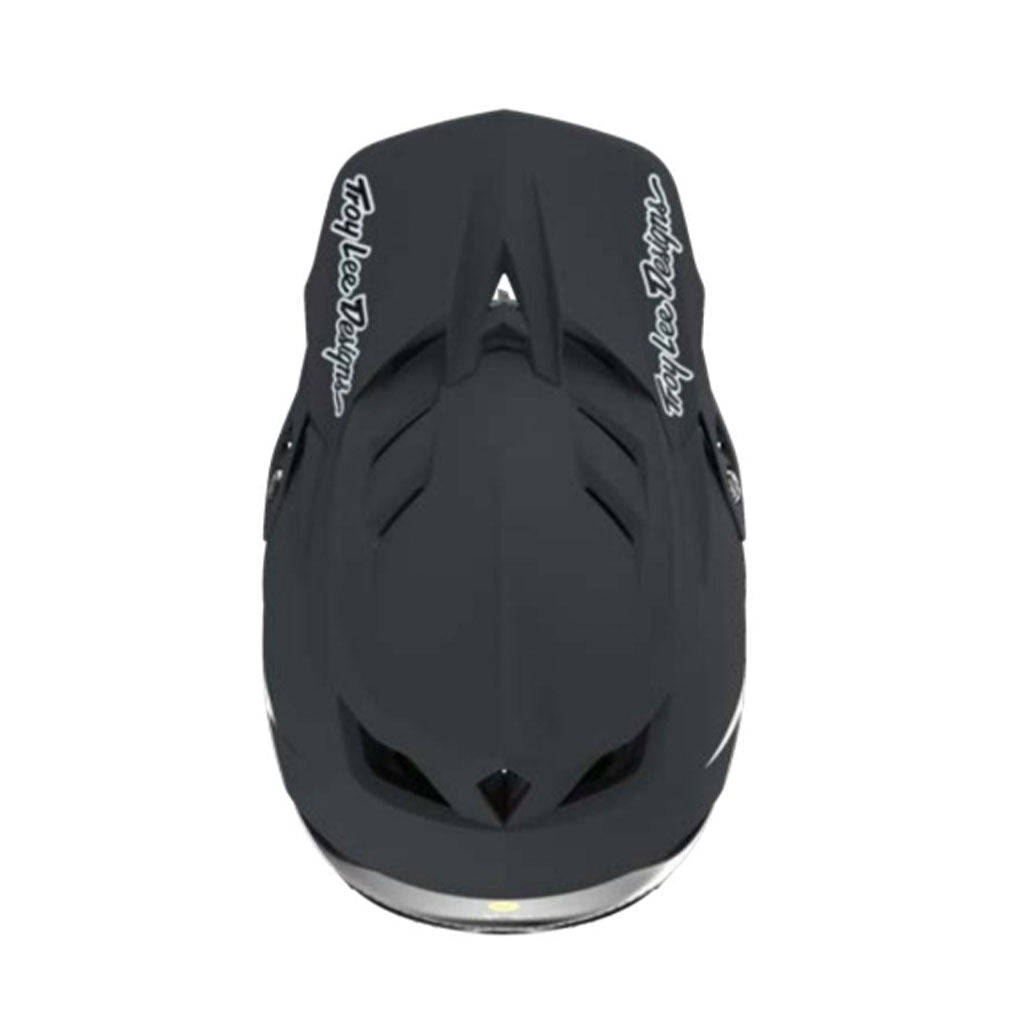 Aerial view of the TLD 25.1 D4 Carbon Helmet MIPS Stealth Black with white text on the sides against a white background, designed for added safety.