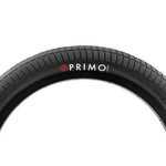 Close-up of a black Primo V Monster Tyre with a directional tread pattern and the Primo logo in white and red on the sidewall, offering excellent traction.