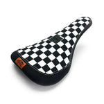 The Cult X Vans Slip On Pro Pivotal Seat features a black and white checkers pattern, highlighted by a distinct small orange tag on the side.