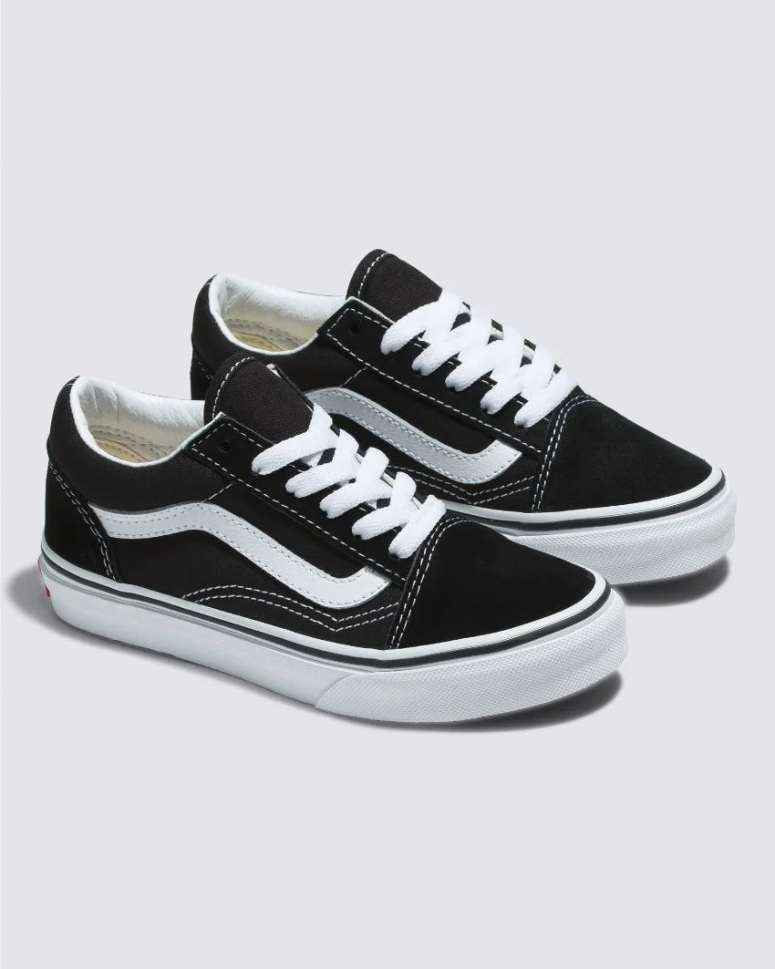 Pair of Vans Kids Old Skool Black/White low-top shoes featuring white laces and a wavy stripe design on the side, ideal for stylish young children, showcased against a simple background.